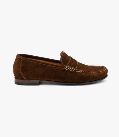 A side view capturing the sleek silhouette of the Loake Jefferson Brown Suede Loafer, showcasing its refined design and premium suede leather material. The apron slip-on style adds a touch of sophistication to the ensemble.