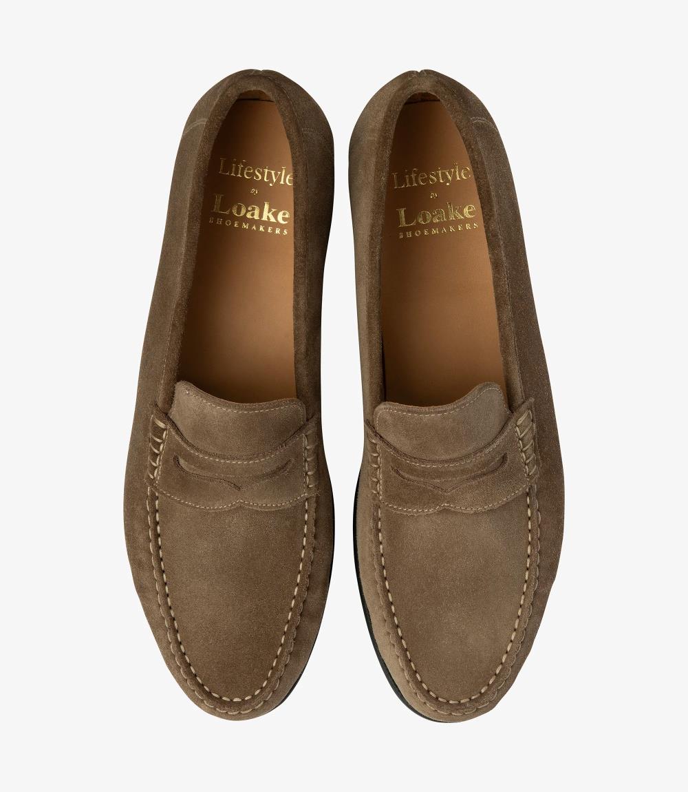 A bird's-eye view presenting a pair of Loake Jefferson Flint Suede Loafers, perfectly aligned to showcase their symmetrical design and meticulous craftsmanship. The rich flint suede and fine stitching details are evident from this perspective, epitomizing timeless style and refinement.