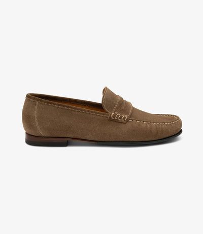 A side view capturing the sleek silhouette of the Loake Jefferson Flint Suede Loafer, showcasing its refined design and premium suede leather material. The apron slip-on style adds a touch of sophistication to the ensemble.