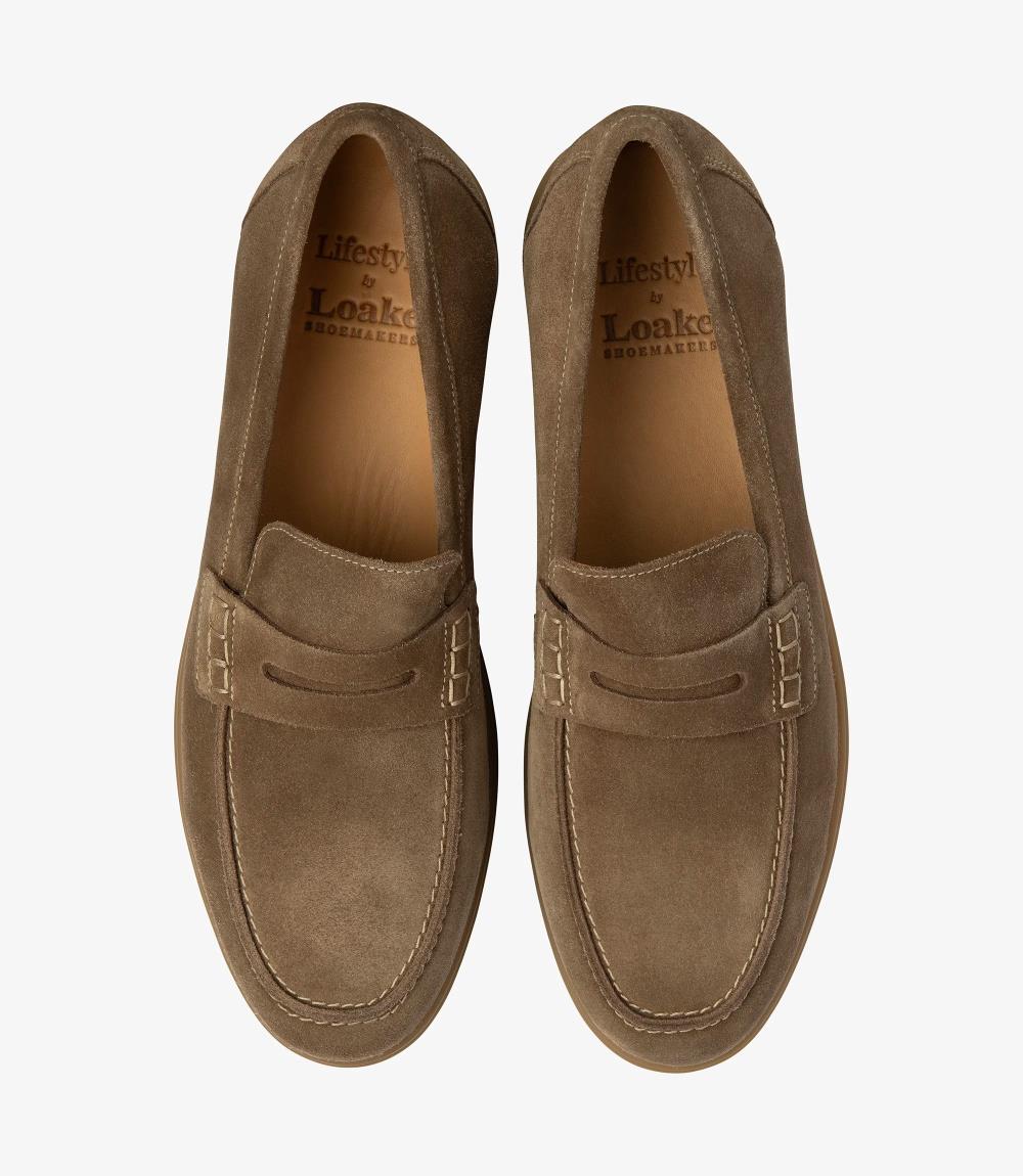 A bird's-eye view presenting a pair of Loake Lucca Flint Suede Loafers, perfectly aligned to showcase their symmetrical design and meticulous craftsmanship. The rich flint suede and fine stitching details are evident from this perspective, epitomizing timeless style and refinement.