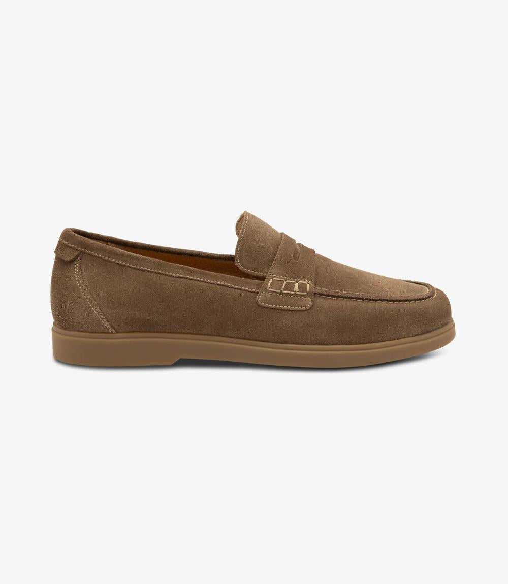 A side view showcasing the sleek silhouette of the Loake Lucca Flint Suede Loafer, highlighting its refined design and premium suede material. The saddle apron detail adds a touch of sophistication to the ensemble.