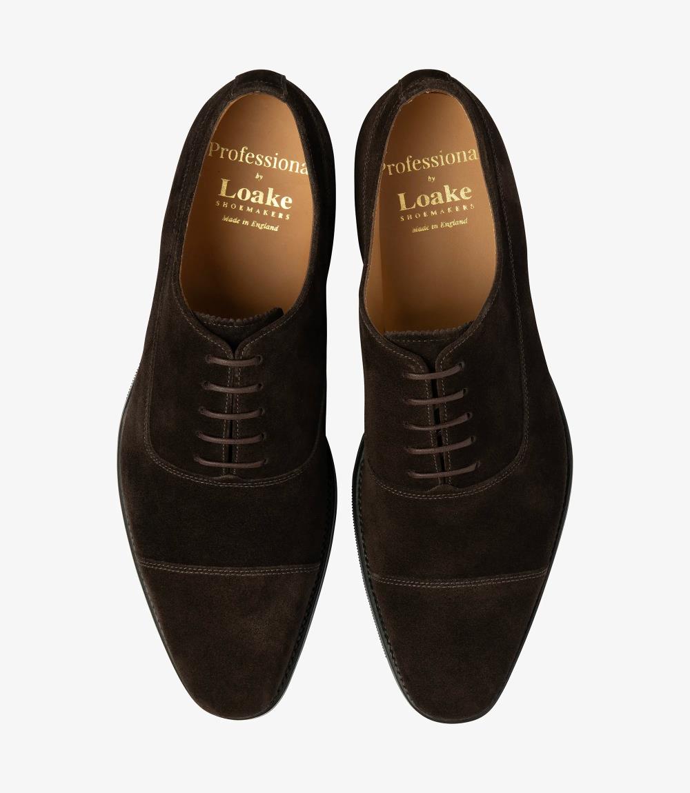 A bird's-eye view captures the symmetry and elegance of the Loake Truman Dark Brown Suede Oxford. The matching pair showcases the luxurious suede leather construction and sleek Oxford design. Perfectly crafted for formal occasions or professional attire, these shoes are a testament to classic style and superior craftsmanship.