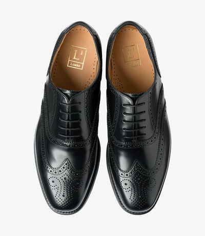 A top-down view of two Loake 302 Black Leather Oxford Brogues, perfectly symmetrical in design and craftsmanship. The polished black leather and intricate brogue patterns are evident, reflecting the quality and attention to detail in each pair.
