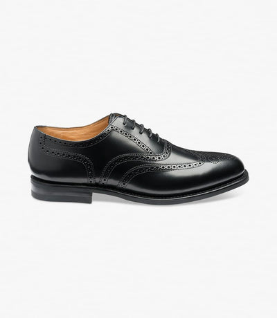 A side view of the Loake 302 Black Leather Oxford Brogues, showcasing their sleek silhouette and polished leather finish. The Goodyear welted rubber soles ensure durability and traction, while the intricate brogue detailing adds a touch of sophistication.