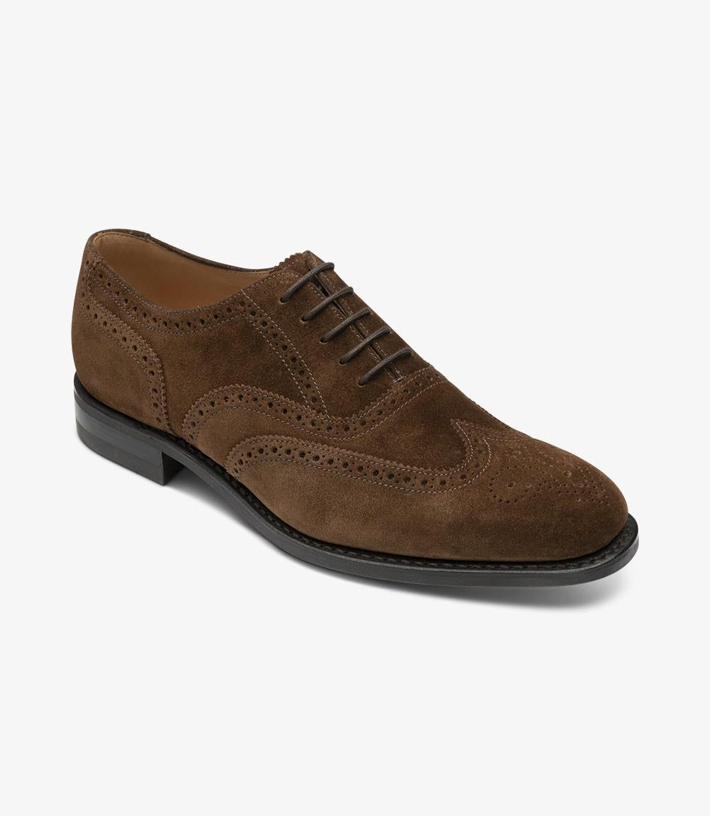 An angled shot capturing the dynamic lines and contours of the Loake 302 Brown Leather Oxford Brogues. The rich brown leather and suede accents are highlighted from this perspective, emphasizing the classic yet modern design of these shoes.