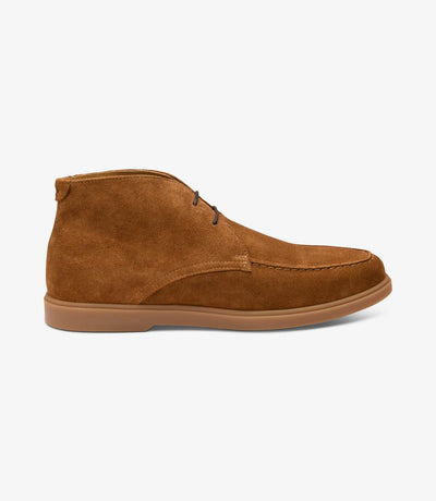 The Loake Amalfi Chestnut Suede Chukka Boots boast a sleek silhouette, showcasing the supple suede material and durable rubber soles, epitomizing casual sophistication.