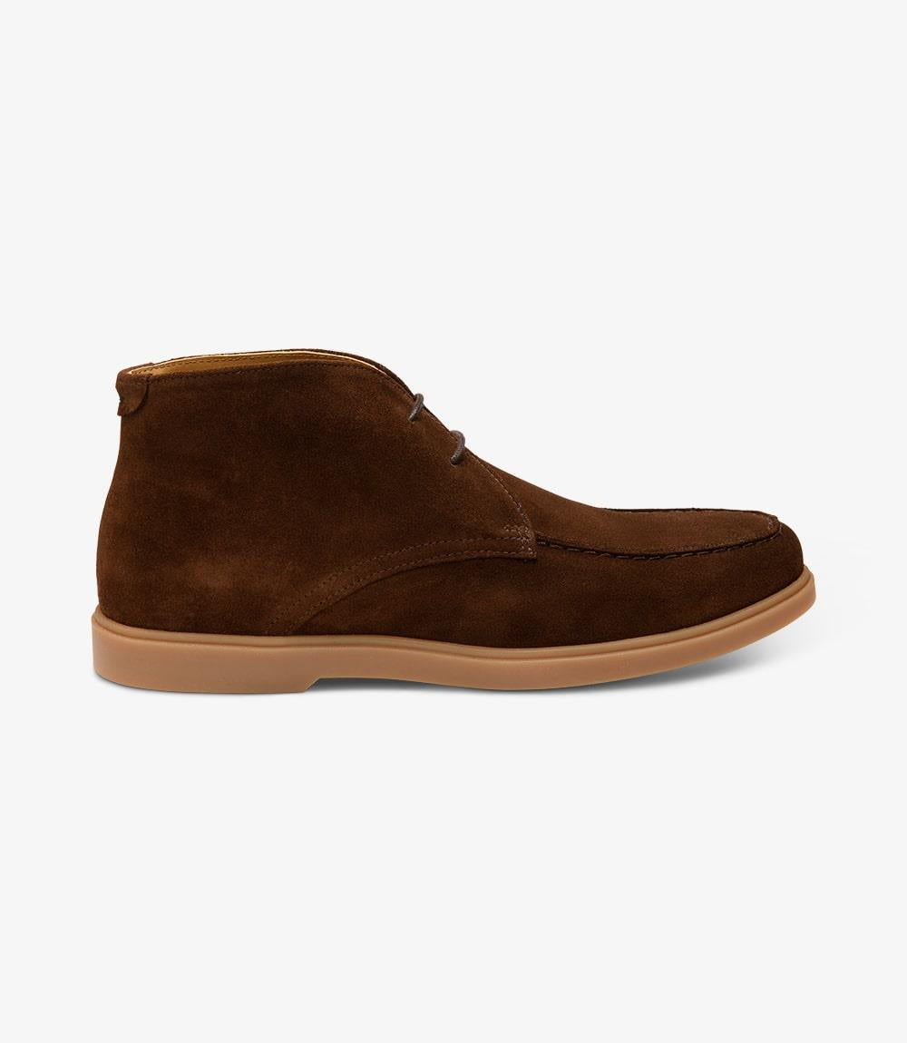 A close-up of the Loake Amalfi Chocolate Suede Chukka Boot showcasing its sleek silhouette and rich suede texture. The apron chukka design adds a touch of sophistication, while the cemented rubber sole ensures durability and traction.