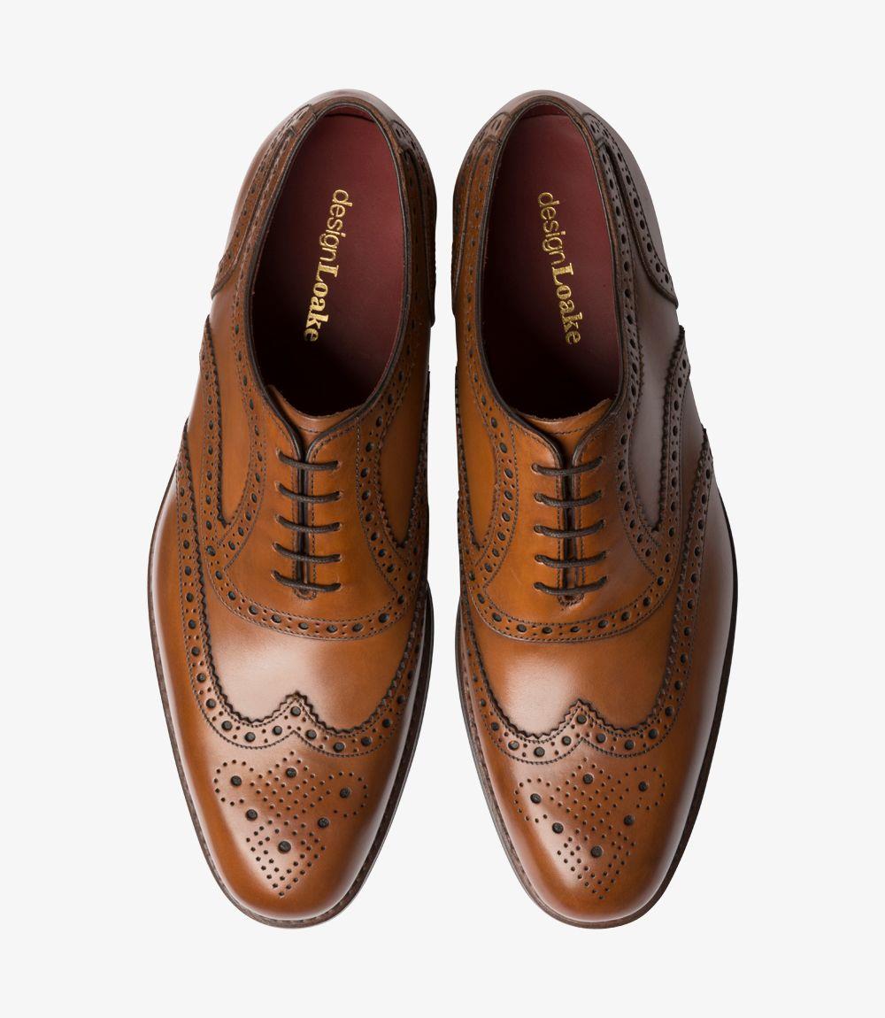 From above, the pair of Kerridge Cedar Oxfords reveals their symmetrical brogue detailing across the toe caps, complemented by traditional Oxford lacing that emphasizes the shoe’s classic design. The warm cedar leather is polished to a smooth, even finish, while the subtle elongation of the toe enhances its refined look. The fully leather-lined interiors peek out, showcasing the shoe’s high-quality craftsmanship and commitment to comfort.