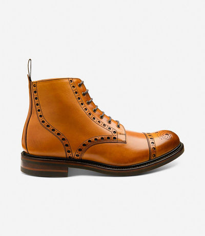 A side view of the Loake Loxley Tan Boot, showcasing its rugged silhouette and premium hand-painted calf leather upper. The Goodyear welted victory rubber soles are prominently featured, symbolizing durability and quality craftsmanship.