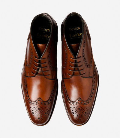 A bird's-eye view captures the symmetry and elegance of the Loake Sywell Cedar Brogue Boots. The matching pair displays the intricate brogue detailing and hand-painted leather, making them a stylish choice for both formal occasions and everyday wear.