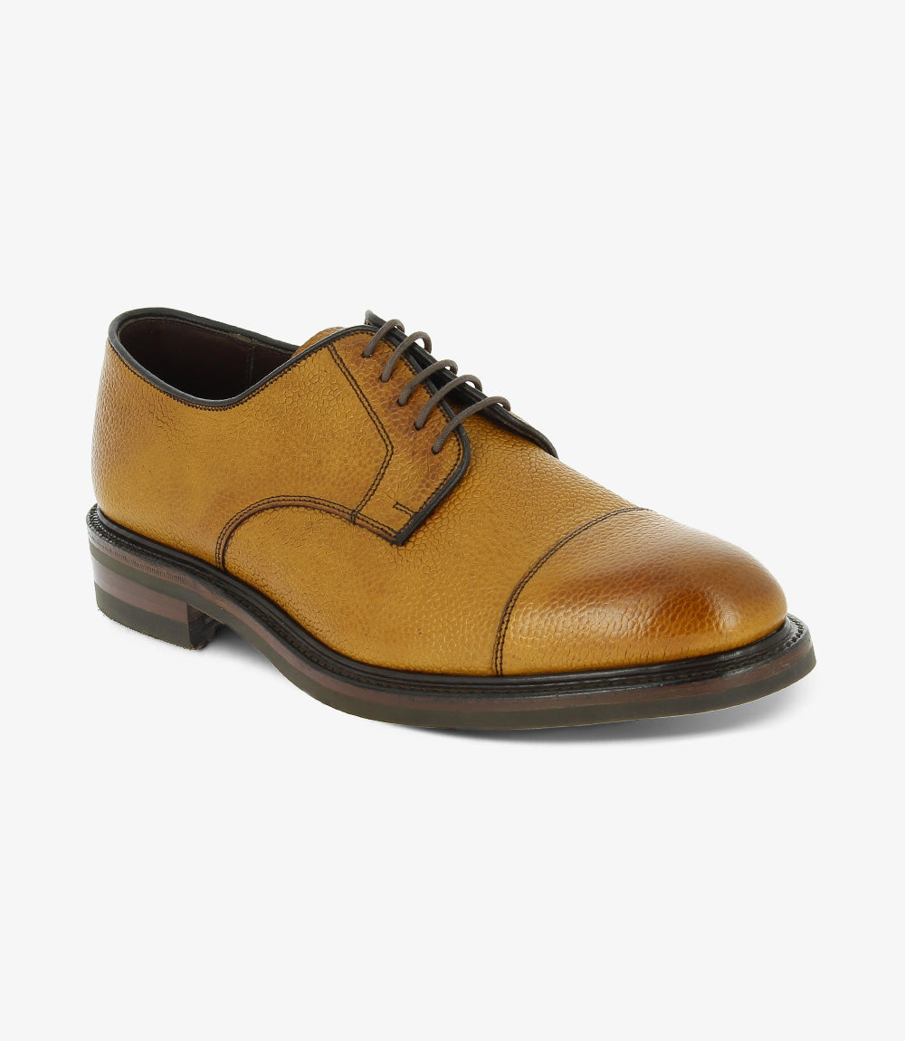 An angled shot captures the shoe from the side and slightly above, showcasing the robust Goodyear welted construction, fine stitching along the seams, and the curve of the Victory rubber sole, which provides a hint of its traction capabilities.