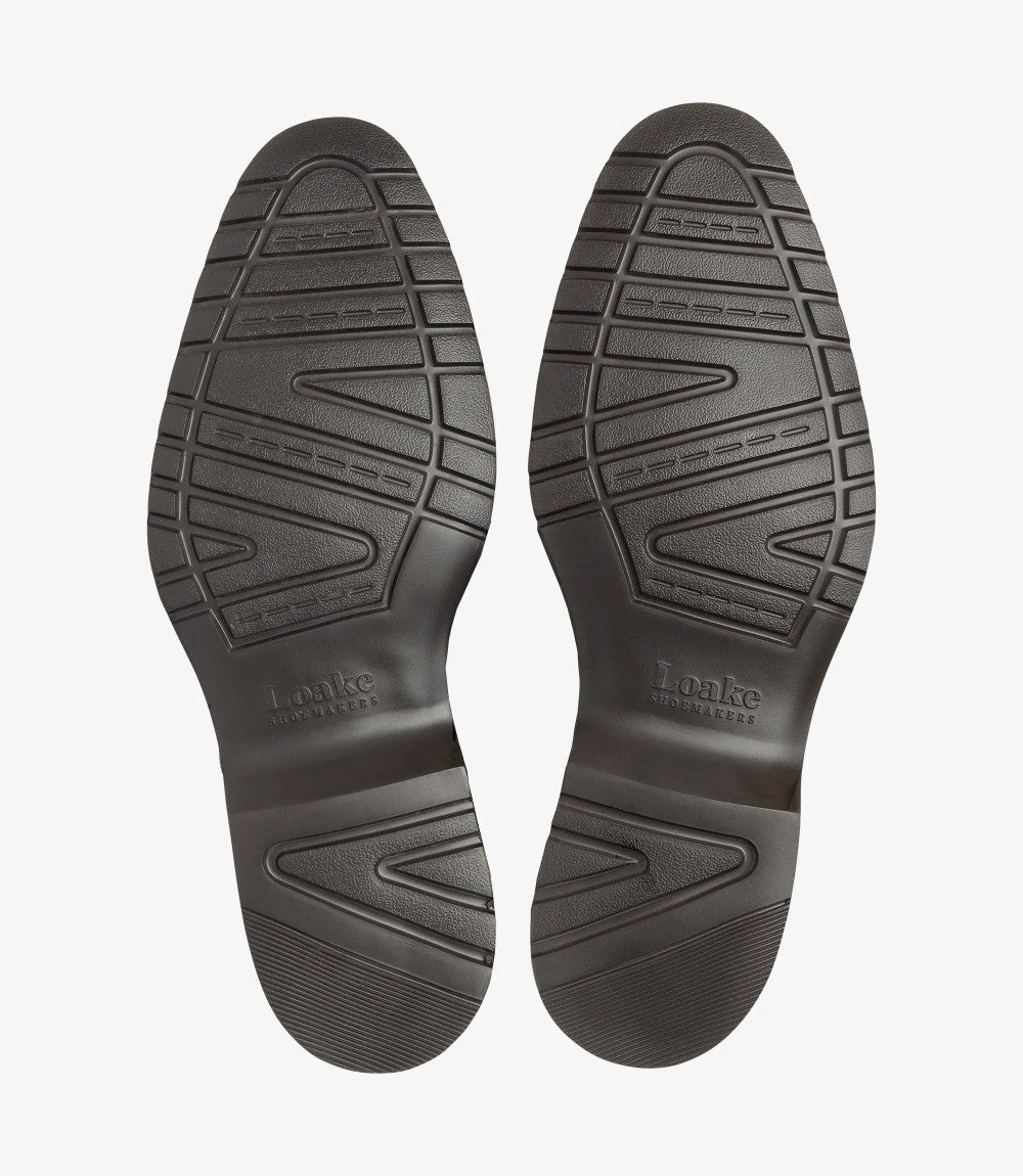 A flat lay showing the underside of both boots, featuring the EverLight rubber sole tread pattern and embossed Loake branding.