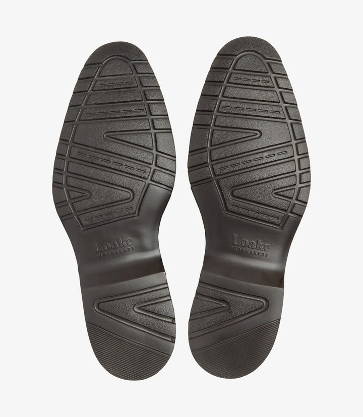 A flat lay showing the underside of both boots, featuring the EverLight rubber sole tread pattern and embossed Loake branding.