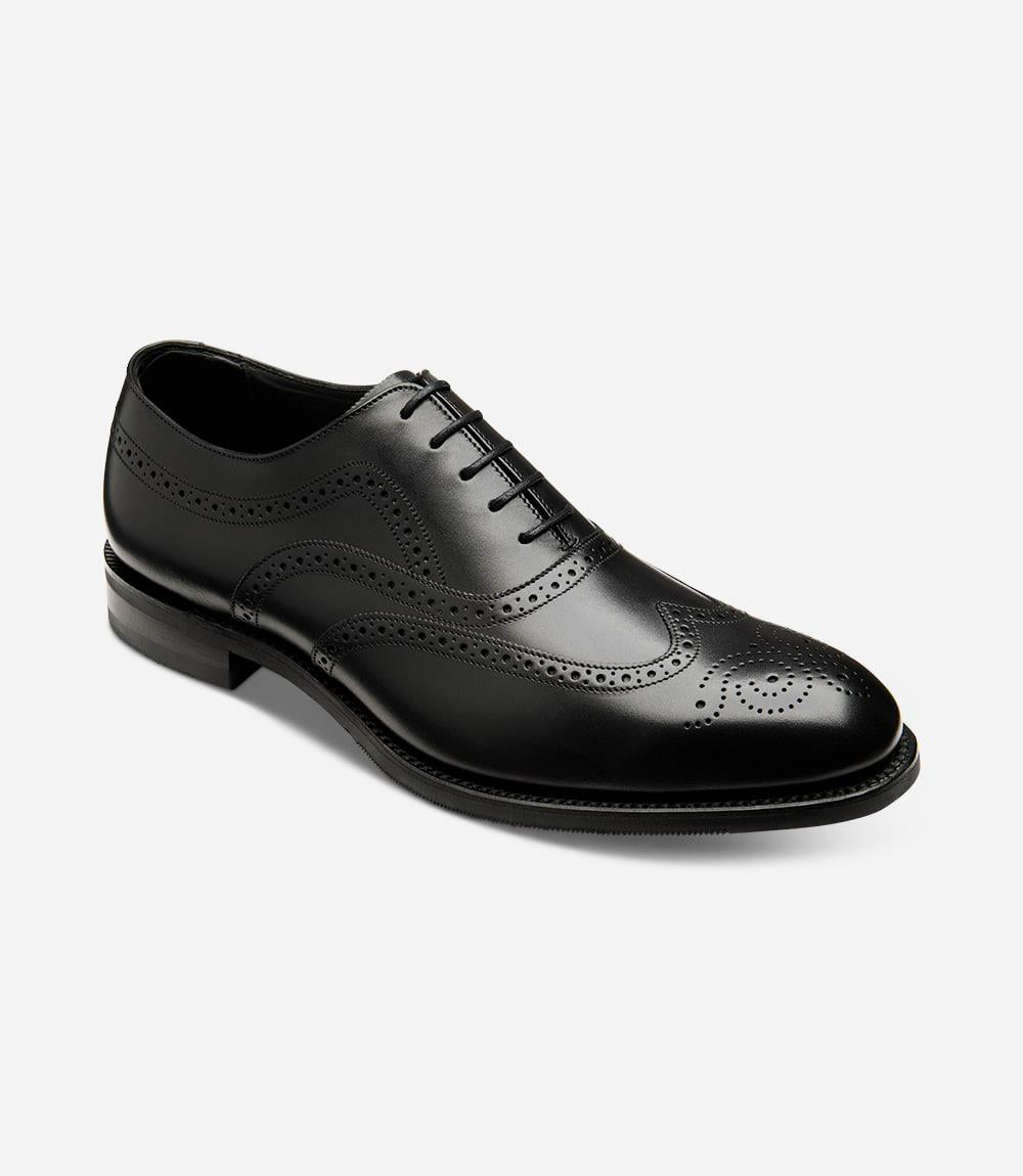 Emphasizes the refined design of the shoe, including the rounded toe and the quality of the leather. The angle view highlights the curvature of the shoe and the meticulous stitching that defines its premium construction.