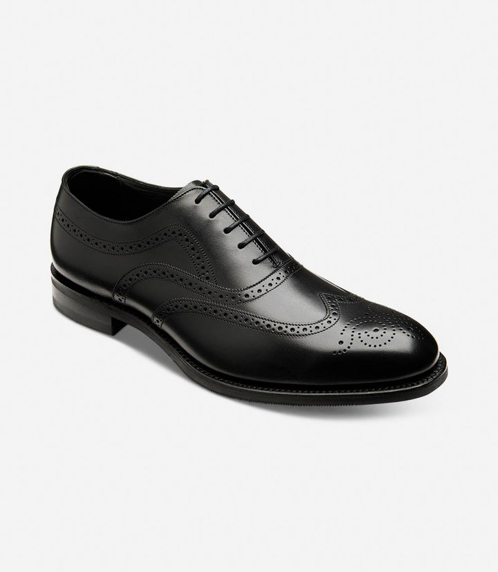 Emphasizes the refined design of the shoe, including the rounded toe and the quality of the leather. The angle view highlights the curvature of the shoe and the meticulous stitching that defines its premium construction.