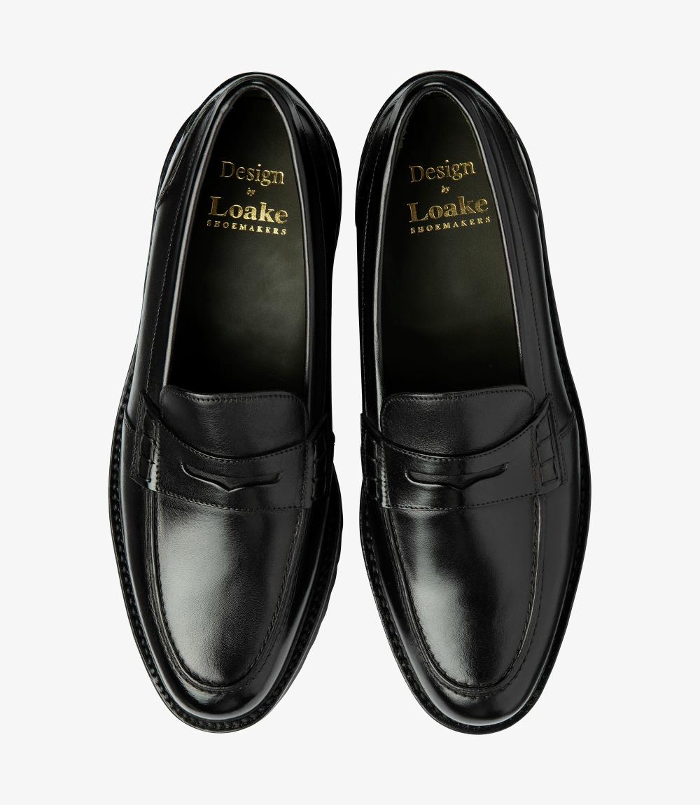 A bird's-eye view captures the symmetry and elegance of the Loake Crux Black Loafer. The matching pair showcases the premium calf leather construction and innovative design. Perfect for both formal occasions and everyday wear, these loafers are a testament to contemporary style and superior craftsmanship.