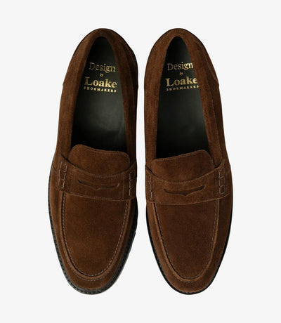 A bird's-eye view captures the symmetry and elegance of the Loake Crux Brown Suede Loafer. The matching pair showcases the premium suede leather construction and innovative design. Perfect for both formal occasions and everyday wear, these loafers are a testament to contemporary style and superior craftsmanship.