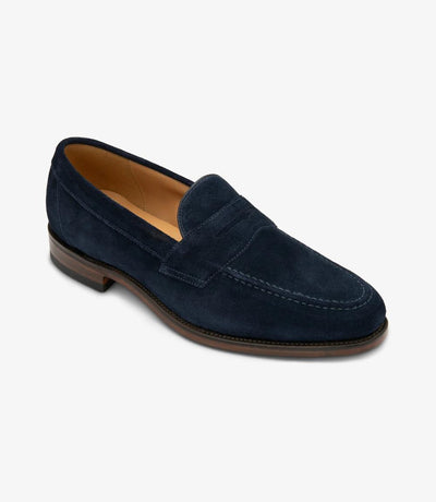 Captured from an angle, the outside profile of the Imperial Loafer reveals its impeccable craftsmanship and refined details, highlighting the rich navy suede and the fine stitching, symbolizing sophistication and style.