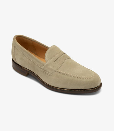 Captured from an angle, the outside profile of the Imperial Loafer reveals its exquisite craftsmanship and refined details, highlighting the rich sand suede and the sleek lines, symbolizing timeless elegance and versatility.
