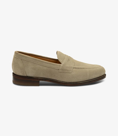 The outside profile of the Loake Imperial Sand Suede Loafer showcases its sleek silhouette, featuring a classic apron penny loafer design, crafted from premium suede leather for a sophisticated look.