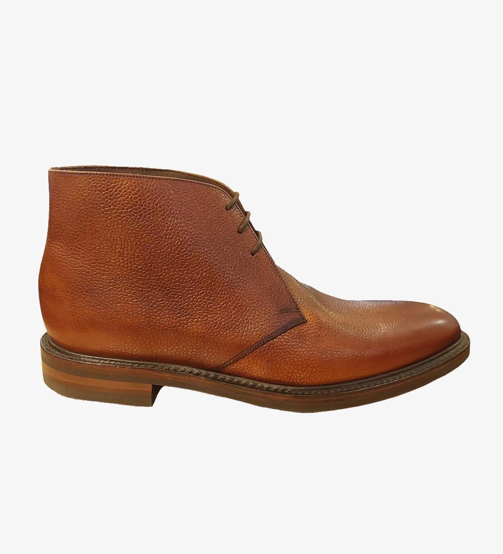 A detailed image of the Lytham-DIS Brown Derby Boot from the side, showcasing the grain burnished calf leather finish and the sturdy Goodyear welted stud rubber sole. The classic derby design and robust construction are clearly visible.