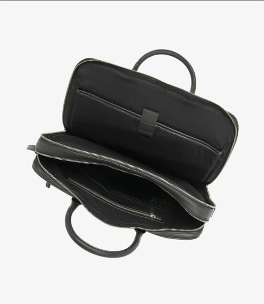A detailed view of the interior of the Westminster Black Grain Leather Briefcase, revealing a spacious compartment designed to accommodate a laptop. The interior features a single zip pocket for organized storage, with the leather’s rich texture visible. The briefcase’s interior is well-lit to showcase its practical and stylish design.