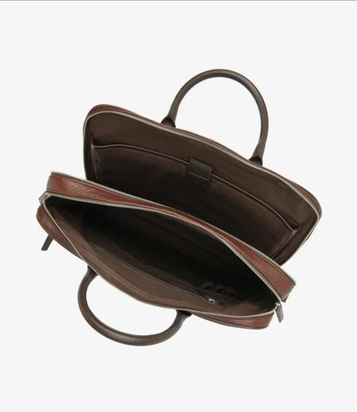 A detailed view of the interior of the Westminster Dark Brown Grain Leather Briefcase, showcasing its spacious compartment designed to fit a laptop securely. The interior includes a single zip pocket for organized storage. The leather's rich texture and practical layout are clearly visible, with the briefcase's thoughtful design in focus.