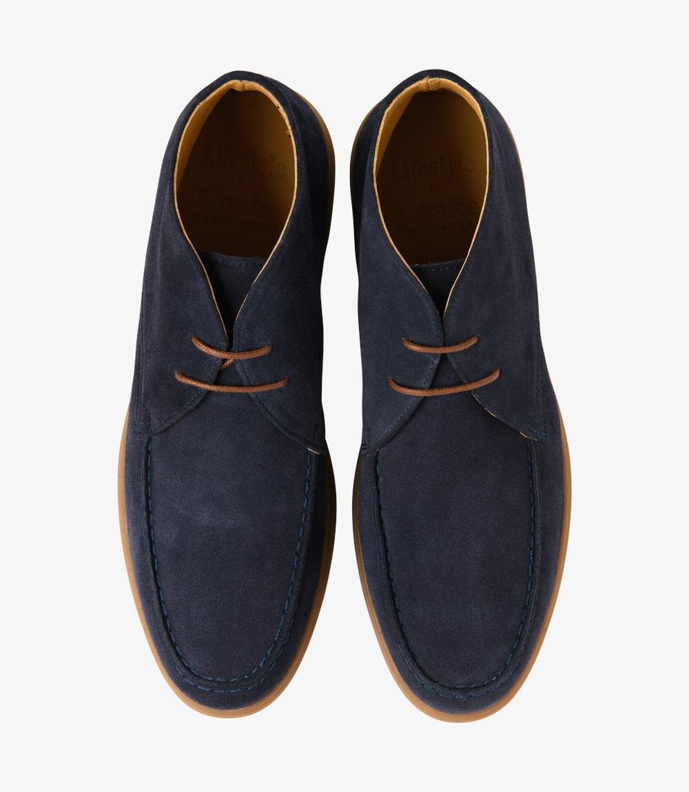 A bird's-eye view of a pair of Loake Amalfi Navy Suede Chukka Boots, perfectly aligned to showcase their symmetrical design and meticulous craftsmanship. The deep navy hue and fine stitching deta