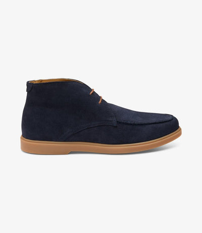 A close-up of the Loake Amalfi Navy Suede Chukka Boot, showcasing its sleek silhouette and rich navy suede texture. The apron chukka design adds sophistication, while the cemented rubber sole ensures durability and traction.