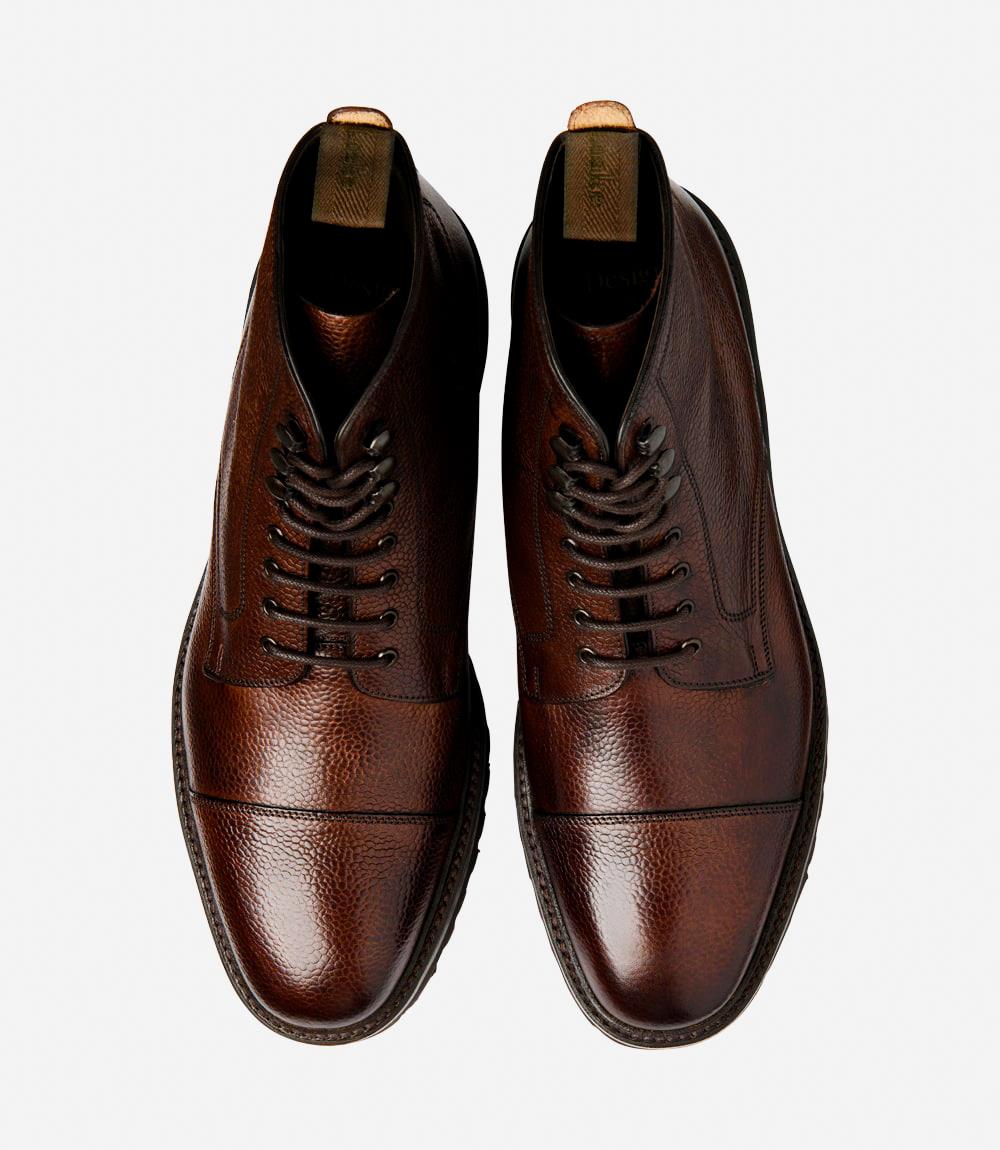 A bird's-eye view captures the symmetry and elegance of the Loake Aquarius Dark Brown Grain Derby Boots. The matching pair showcases the hand-painted grain leather and classic Derby boot design. Perfect for both casual outings and formal occasions, these boots exude timeless style and exceptional quality.