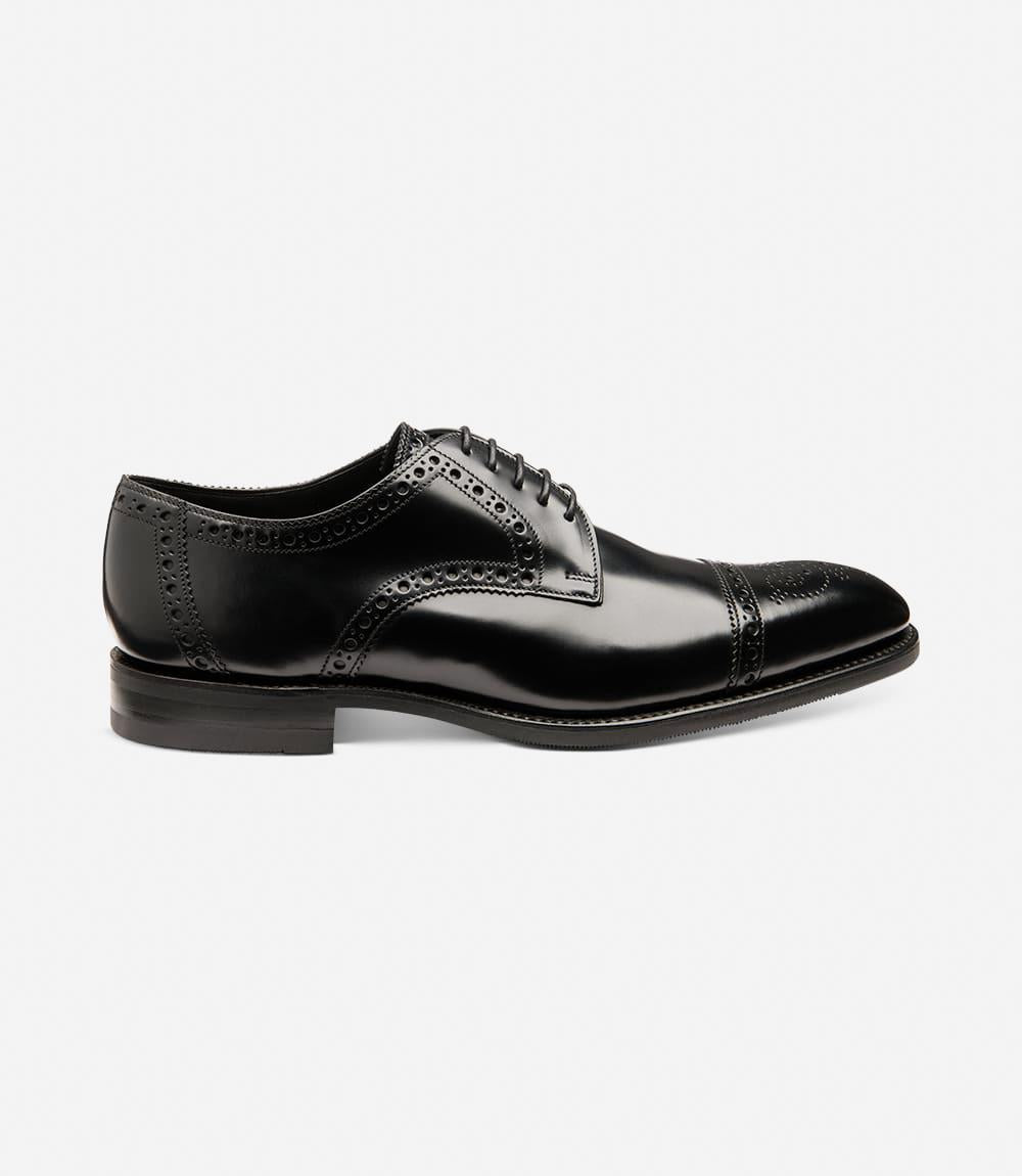 The outside profile of the Loake Eldon Black Polished Derby Semi-Brogue showcases its sleek silhouette, featuring a straight toe-cap with intricate punched detailing, exuding classic sophistication.