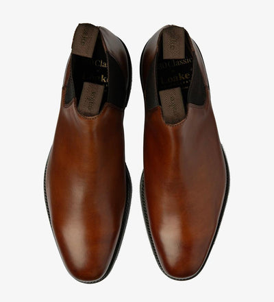A top-down view of two Loake Emsworth Cedar Chelsea Boots, perfectly symmetrical in design and craftsmanship. The luxurious calf leather and meticulous stitching detail are evident, showcasing the impeccable quality of these British-made boots.