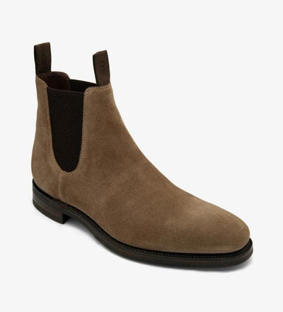 An angled shot capturing the dynamic lines and contours of the Loake Emsworth Flint Suede Chelsea Boot. The rich suede leather and Goodyear welted rubber sole are highlighted from this perspective, emphasizing both style and functionality.