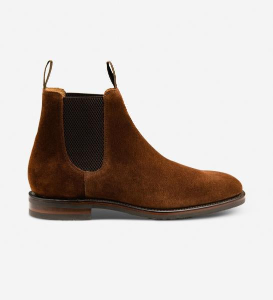 A high-quality image showcases the Loake Emsworth Polo Suede Chelsea Boots in all their elegance. The boots stand tall, highlighting their classic Chelsea design and luxurious suede leather construction. The Goodyear welted rubber soles offer durability and grip, while the British craftsmanship is evident in every meticulous detail.