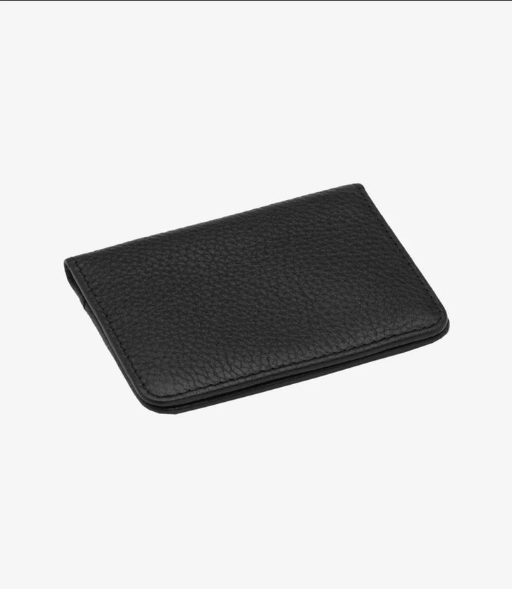 The closed view of the Loake Fenchurch Black Grain Wallet showcases its sleek and refined design. Crafted from premium black grain leather, the wallet features a smooth, textured surface that exudes elegance and sophistication. The edges are neatly stitched, reflecting the high-quality craftsmanship synonymous with the Loake brand. Its compact dimensions make it ideal for easy carrying, while the classic black color ensures it complements any style.