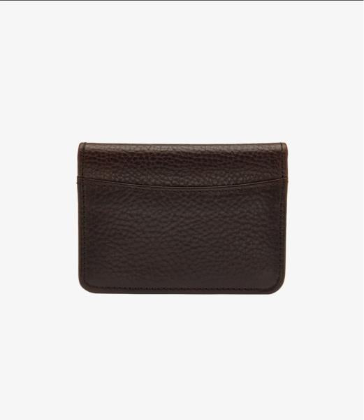 The closed view of the Loake Fenchurch Dark Brown Grain Wallet highlights its elegant and structured design. Crafted from premium dark brown grain leather, the wallet features a textured surface that adds a touch of sophistication. Its compact dimensions make it easy to carry, while the understated design ensures it complements any style. The wallet's edges are neatly stitched, showcasing the meticulous craftsmanship that Loake is known for.