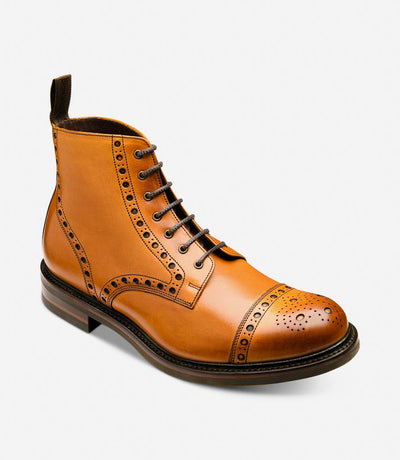 An angled shot capturing the dynamic lines and contours of the Loake Loxley Tan Boot. The rich hand-painted calf leather and intricate detailing are highlighted from this perspective, emphasizing the rugged sophistication of these boots.