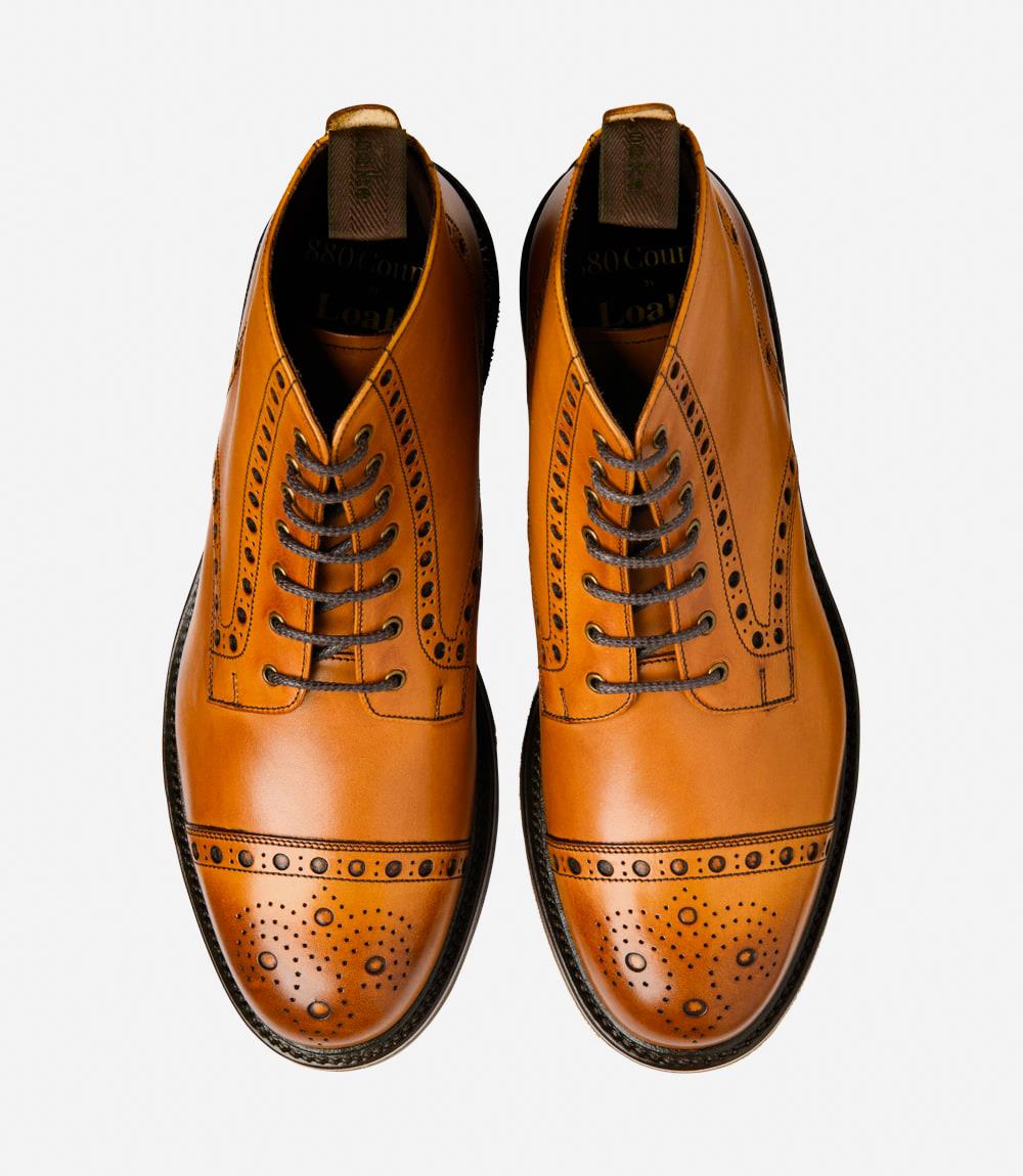 A top-down view of two Loake Loxley Tan Boots, perfectly symmetrical in design and craftsmanship. The hand-painted leather and classic punched-toe detailing are evident, reflecting the quality and attention to detail in each pair.