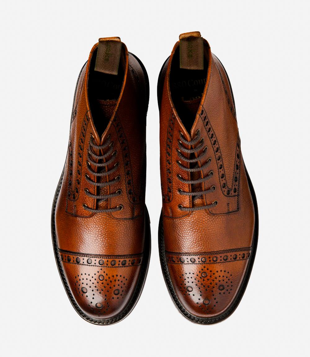 A top-down view of two Loake Loxley Mahogany Derby Toe Cap Boots, perfectly symmetrical in design and craftsmanship. The hand-painted leather and classic punched-toe detailing are evident, reflecting the quality and attention to detail in each pair.