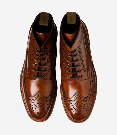 A bird's-eye view captures the symmetry and elegance of the Loake Pegasus Cedar Derby Full-Brogue Boots. The matching pair showcases the hand-painted leather and intricate brogue detailing. Perfect for both formal occasions and everyday wear, these boots exude timeless style and exceptional quality.