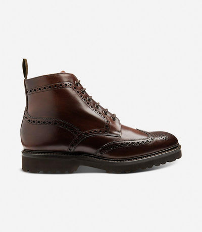 The Loake Pegasus Waxy Dark Brown Derby Full-Brogue Boots showcase a sleek silhouette, featuring hand-painted waxy leather and sturdy commando rubber soles, epitomizing both style and durability.