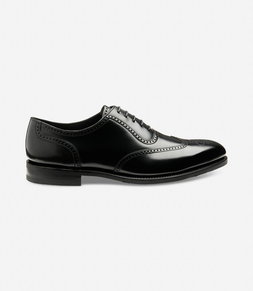 A sleek and refined silhouette of the Loake Tay Black Polished Oxford Semi-Brogue. The polished leather shines elegantly, accentuating the semi-brogue detailing along the vamp. The Goodyear welted shadow rubber sole adds durability and traction, ensuring both style and functionality.