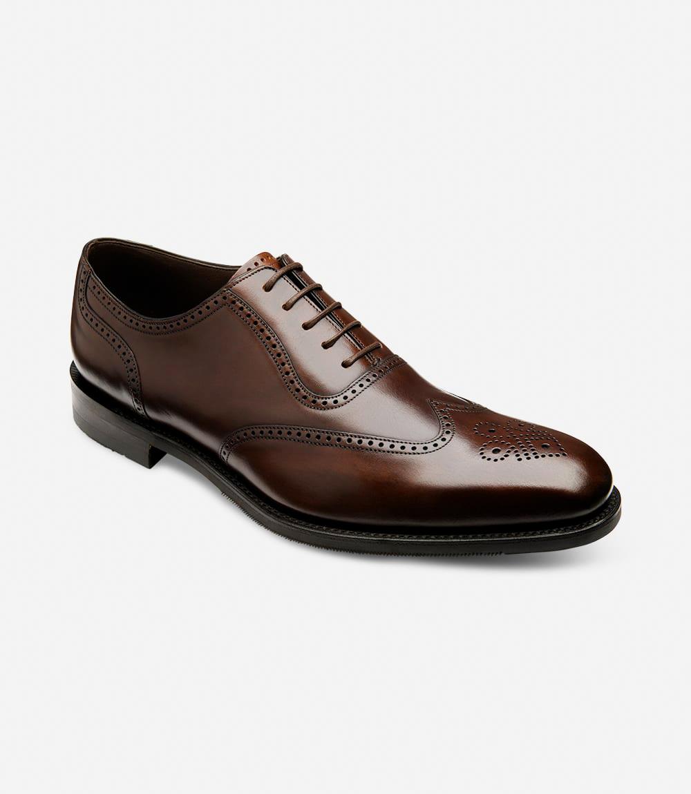 From a dynamic angle, the Loake Tay Dark Brown Polished Oxford Semi-Brogue reveals its meticulous craftsmanship and attention to detail. The polished leather gleams under the light, while the semi-brogue design adds a touch of classic sophistication. The Goodyear welted shadow rubber sole ensures stability and longevity, making it an ideal choice for any occasion.