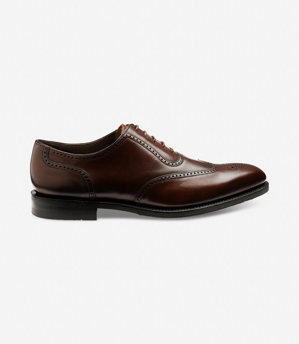 A sleek silhouette of the Loake Tay Dark Brown Polished Oxford Semi-Brogue showcases its polished leather exterior and semi-brogue detailing. The Goodyear welted shadow rubber sole adds durability and grip, perfect for both style and functionality.